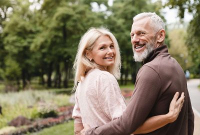 Smiling,Happy,Caucasian,Mature,Spouses,Hugging,Embracing,While,Walking,On